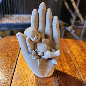 Baby in hand figure (cement)